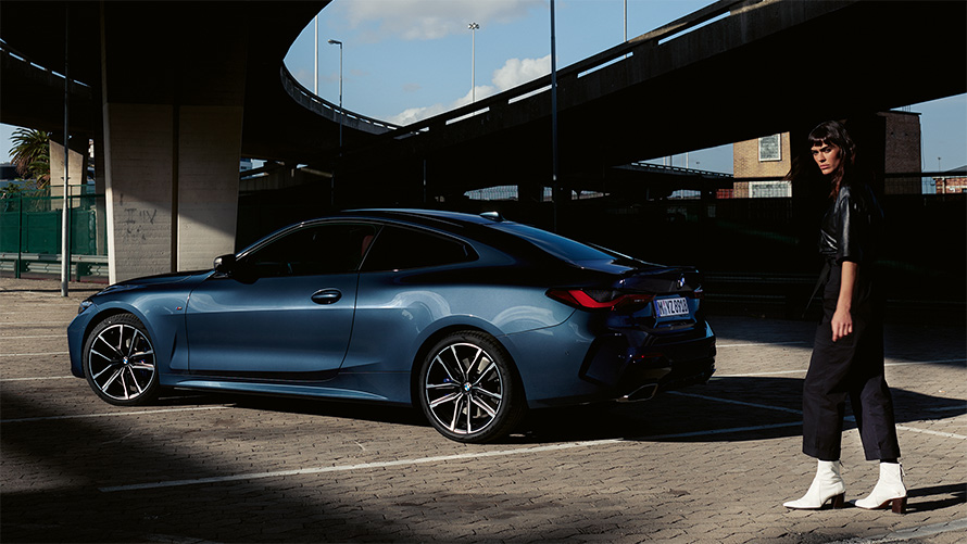 BMW M440i xDrive Coupé G22 2020 в цвете Arctic Race Blue металлик, вид сбоку в три четверти с моделью.